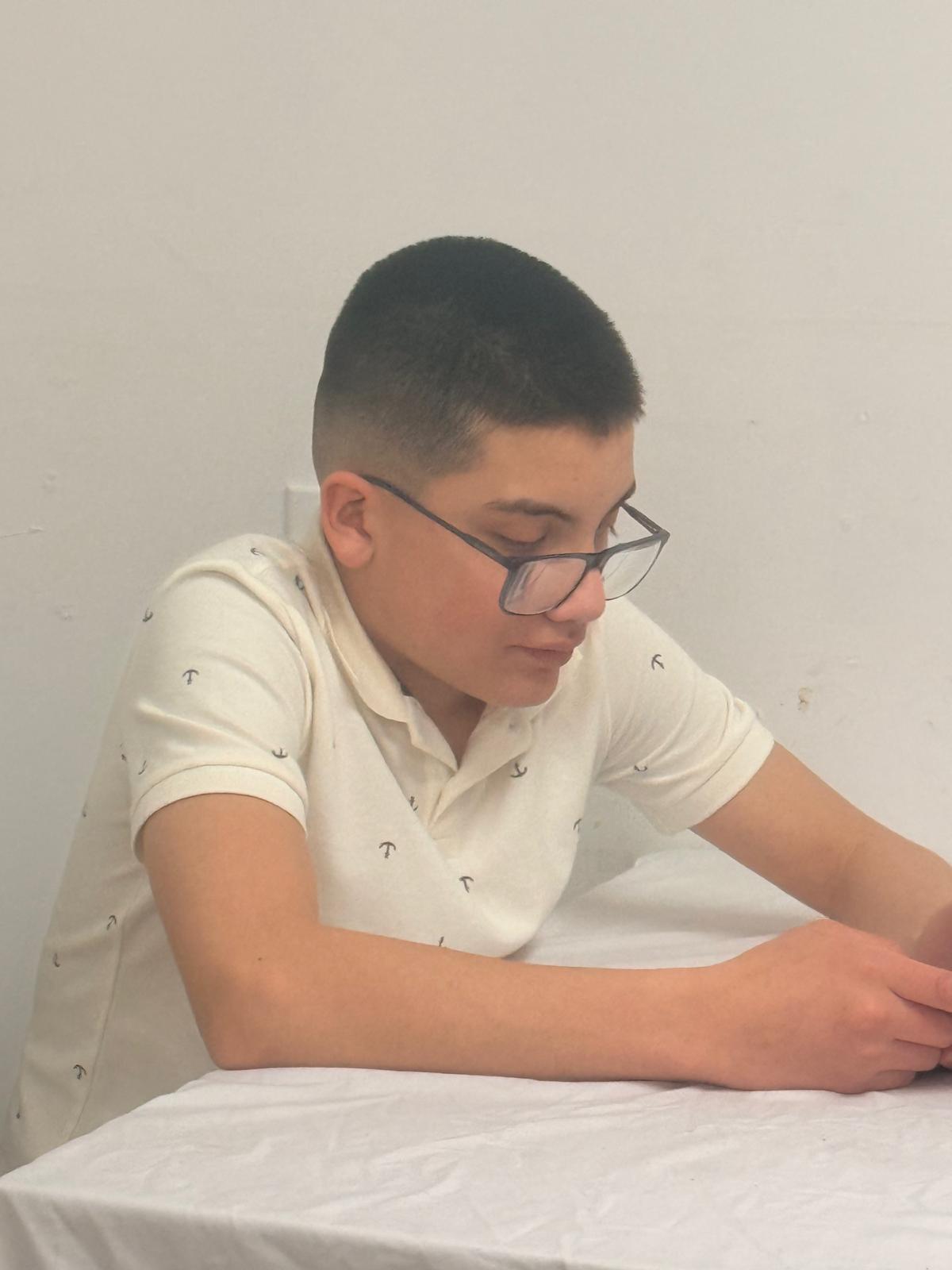 Suleman working at a table